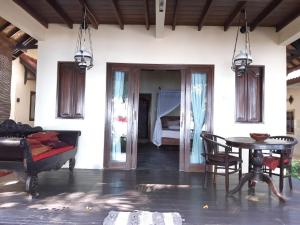 a living room with a table and a bed at Villa coral Cafe in Amed