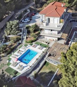 an aerial view of a house with a swimming pool at Pessada Bay Studios and Apartments in Pesádha