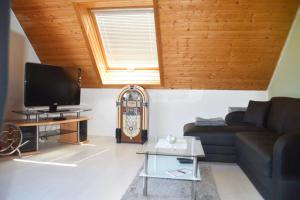 a living room with a couch and a tv at Ferienwohnung Sonnenblick in Albstadt