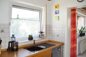 a kitchen with a sink and a window at Ferienwohnung Sonnenblick in Albstadt
