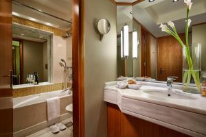 a bathroom with a sink and a toilet and a tub at Rodos Park in Rhodes Town