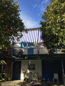 a house with a blue and white roof and trees at SanBart Villetta con Giardino in San Bartolomeo al Mare