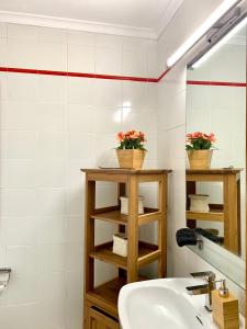 a bathroom with a sink and a mirror at La Playa in Órzola +33 photos
