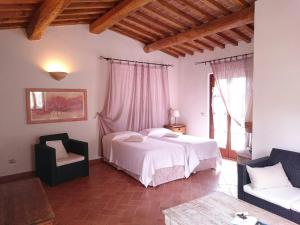 a bedroom with two beds and a couch and a table at Hotel Gallo Nero in SantʼAndrea