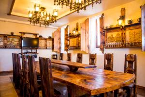 a dining room with a wooden table and chairs at Pushkarskaya Sloboda in Suzdal
