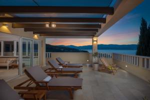 a balcony with chairs and a view of the water at Secret Escape Penthouse in Slatine