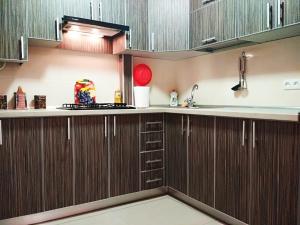 a kitchen with wooden cabinets and a sink at Студия in Kryvyi Rih