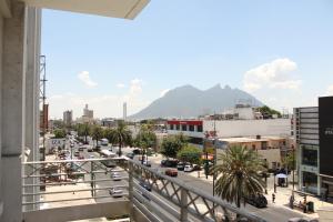 a view of a city from a balcony at Hotel Plaza del Arco Express in Monterrey