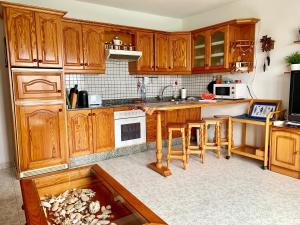 a kitchen with wooden cabinets and a fish tank in the floor at La Playa in Órzola