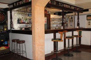 a bar with stools and a pillar in a room at Gasthof-Cafe-Risano in Haslach an der Mühl
