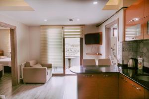 a kitchen with a counter and a living room at İnce Apart Rezidence in Trabzon