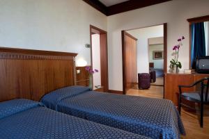Postel nebo postele na pokoji v ubytování Hotel Bellevue