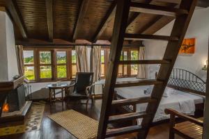 a room with a bunk bed and a table and chairs at Oikoperiigitis Hotel in Kerkini