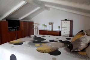 a bedroom with a bed with a black and white comforter at "La Rondinella" Salerno Amalfi Pontecagnano in Pontecagnano