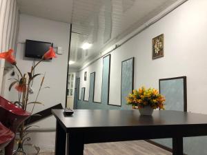a room with a table and flowers on a wall at Metax House Yerevan in Yerevan