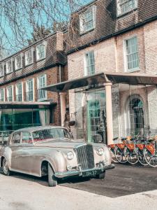 an old car parked in front of a building at Gonville Hotel in Cambridge