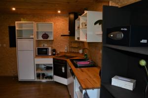 a small kitchen with white cabinets and a counter at Le Toit de Dinant - Esc'Appart in Dinant