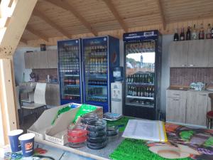 a refrigerator filled with lots of bottles of wine at Cazare tudor&abril in Cojocna