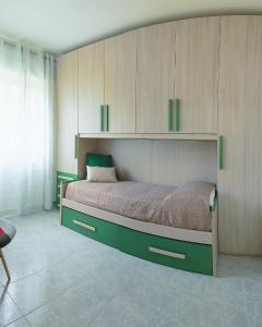a bedroom with a large bed with wooden cabinets at Rivela case vacanze in Ginosa Marina