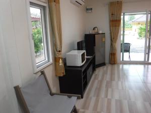 Elle comprend un salon avec un four micro-ondes et un réfrigérateur. dans l'établissement Canachri Resort, à Ban Thung Pho