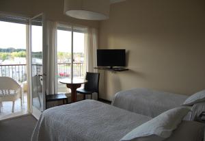 Ένα ή περισσότερα κρεβάτια σε δωμάτιο στο Mercedes Rambla Hotel
