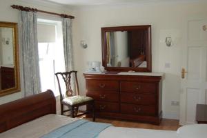 a bedroom with a dresser and a mirror at Teach An Easard in Clifden