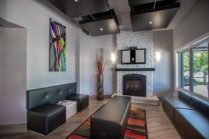 a living room with a couch and a fireplace at Hotel V in Gatineau