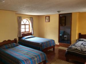 Voodi või voodid majutusasutuse Hostal Curiñan toas