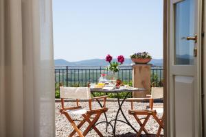 a patio with a table and chairs on a balcony at Tenuta il Sassone - Wine&Food in Massa Marittima