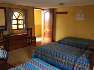 Кровать или кровати в номере Hostal Curiñan