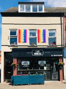 een winkel met regenboog vlaggen in de ramen van een gebouw bij Lwr Ormeau Guest House in Belfast