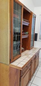 a kitchen with a glass cabinet and a counter top at T3 WALIBI in Estillac