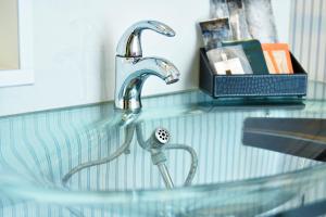 a sink with a faucet on a counter at Nagasaki Chapel Coconuts Hotel ＆Resort in Isahaya