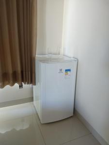 a white refrigerator with two glasses on top of it at Orla Graciosa in Palmas