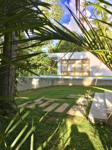 a backyard with a bench and a house at UYANA Boutique Hotel and Retreat ADULTS ONLY in Ahangama