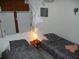Postel nebo postele na pokoji v ubytování BUNGALOW DU VOYAGEUR