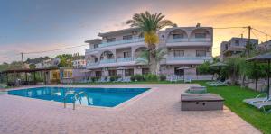 a hotel with a swimming pool in front of a building at Rose Hotel Faliraki in Faliraki