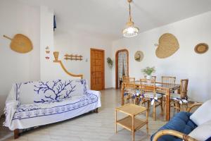 a living room with a couch and a table at Villino Melina in Santa Maria al Bagno