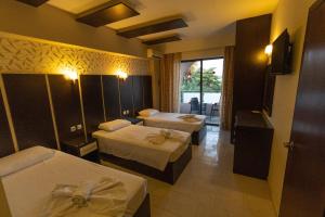 Posteľ alebo postele v izbe v ubytovaní Rose Hotel Faliraki
