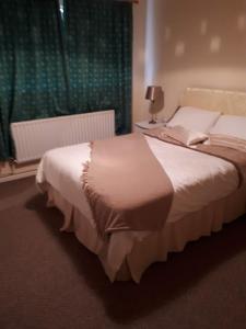 a bedroom with a bed and a window at 3 MacNean Park in Belcoo