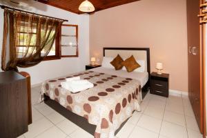 a bedroom with a bed and a window at anna dani in Vourvourou