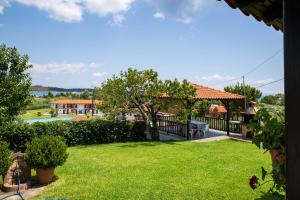a view of a yard with a house at Anna Dani Apartments in Vourvourou