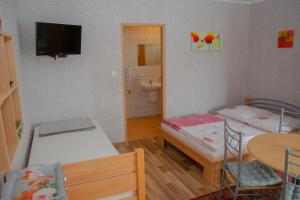 a small room with two beds and a bathroom at Zielona Okiennica Chillout in Chłopy