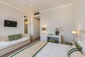a hotel room with a bed and a couch at Grand Hotel & Riviera in Lido di Camaiore