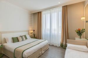 Posteľ alebo postele v izbe v ubytovaní Grand Hotel & Riviera