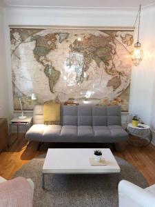 a living room with a map of the world on the wall at Jules & Jim in Montréal