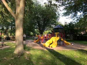 a playground in a park with a yellow slide at Jules & Jim in Montréal