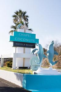 a sign for the chippewa resorts hotel and resort at Nagasaki Chapel Coconuts Hotel ＆Resort in Isahaya