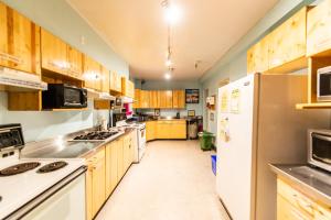 a large kitchen with wooden cabinets and white appliances at Ocean Island Inn in Victoria +127 photos