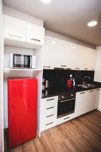 a kitchen with white cabinets and a red refrigerator at Ziva Apartment - 4th floor - Renovated 2019 in Athens +6 photos
